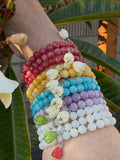 Colorful beaded bracelets on a wrist with a blurred natural background