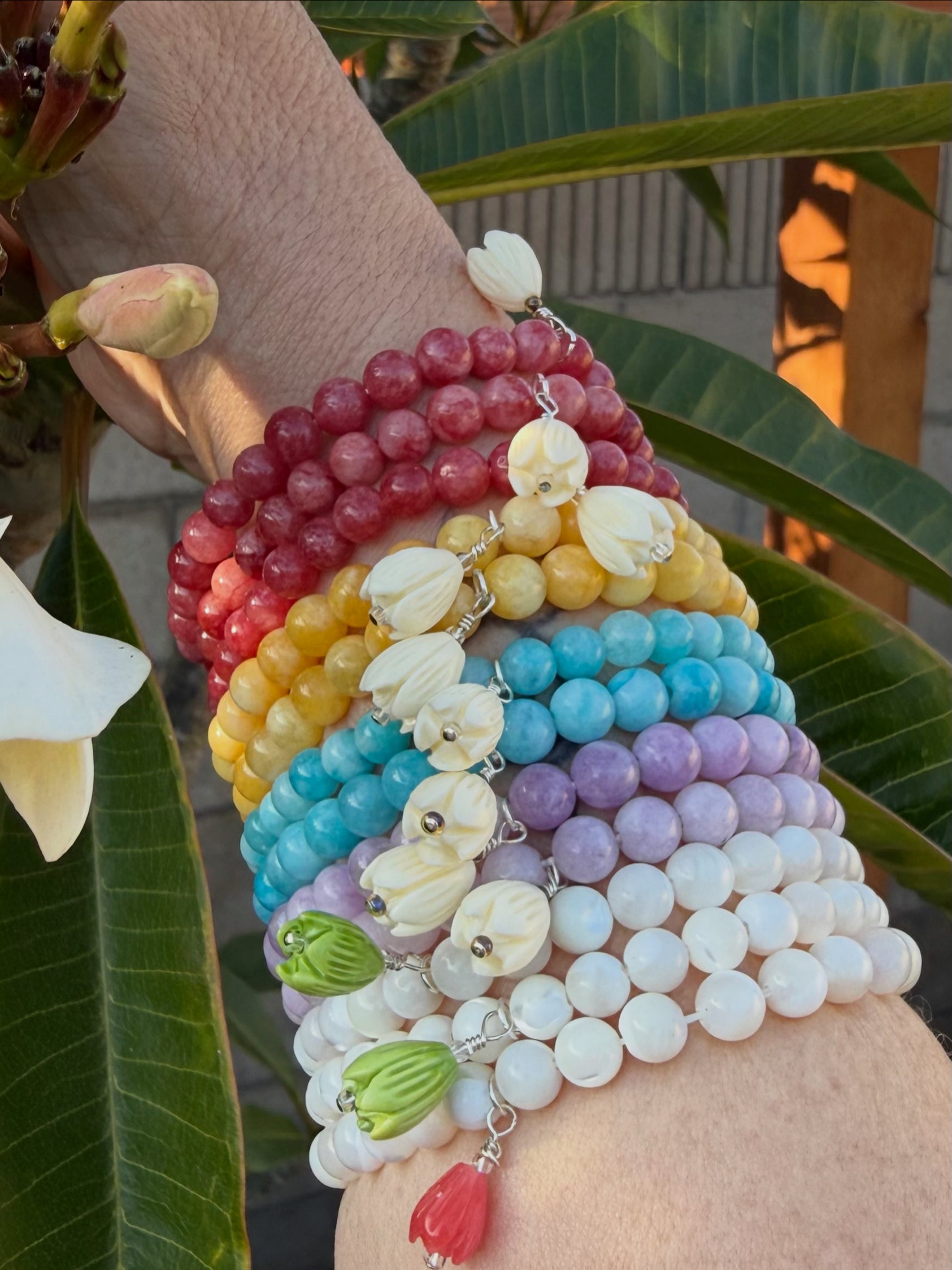 Colorful beaded bracelets on a wrist with a blurred natural background