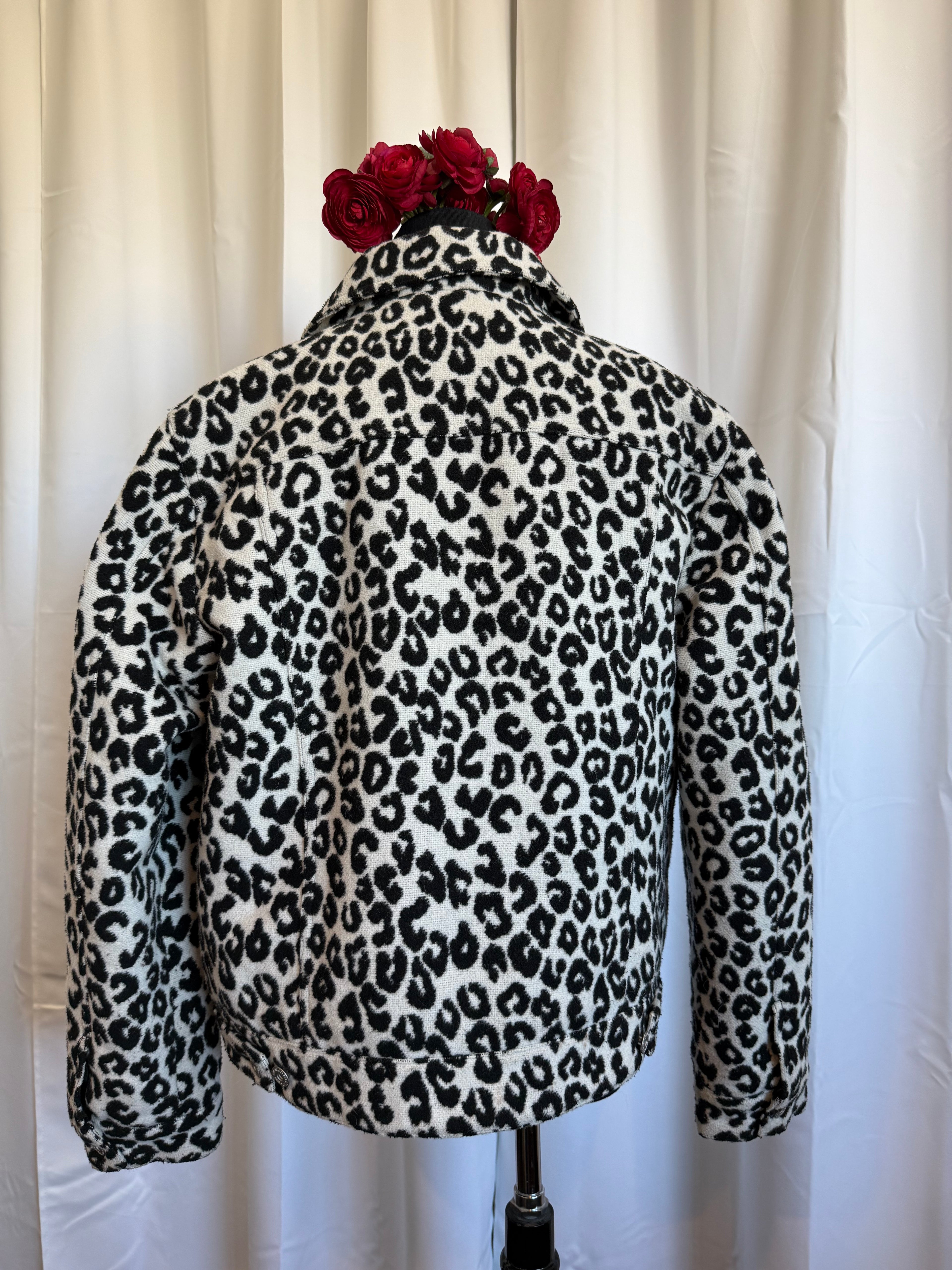 Leopard print jacket with a flower on a white background