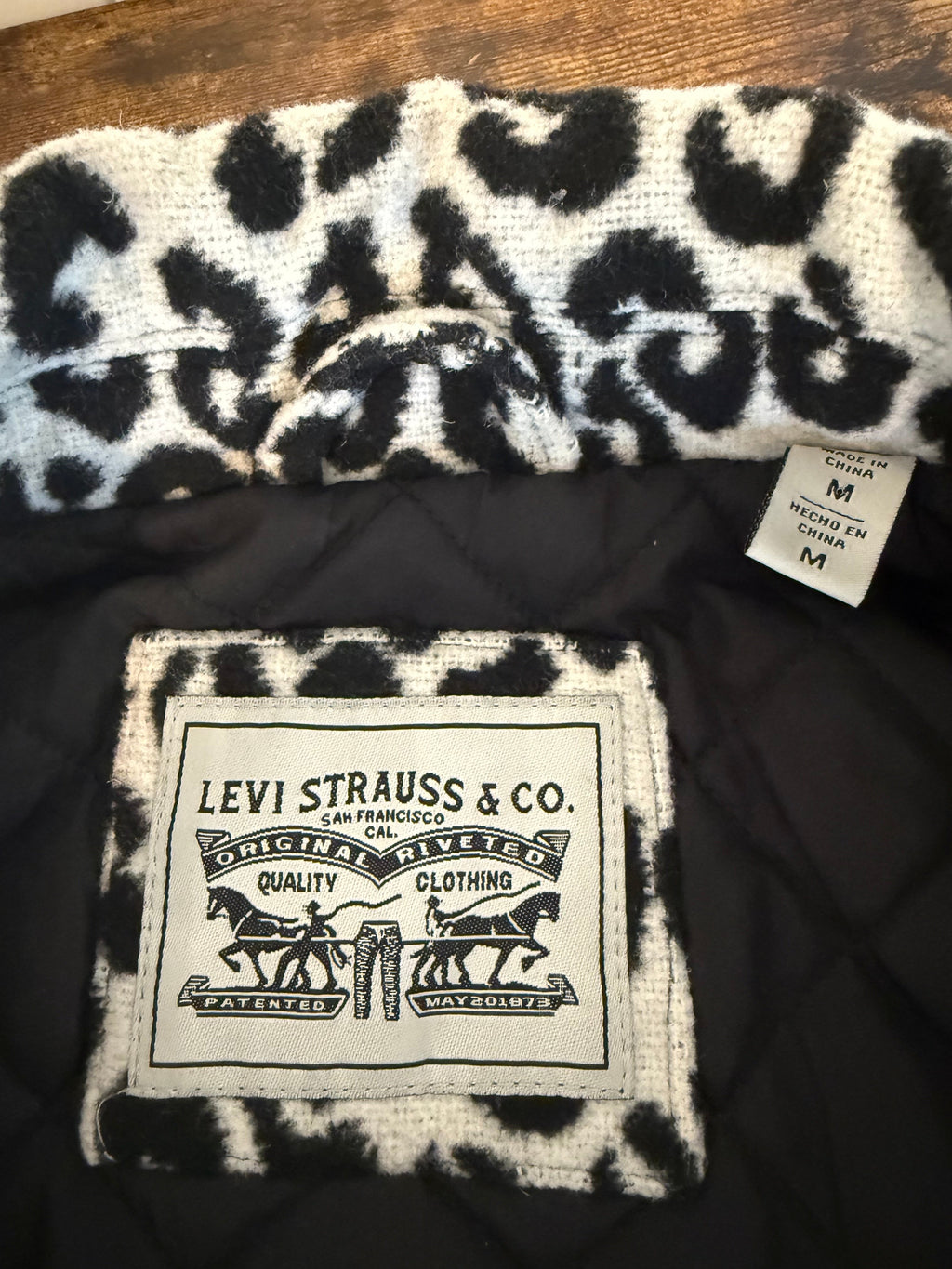 Levi Strauss & Co. branded product with leopard print design on a dark background