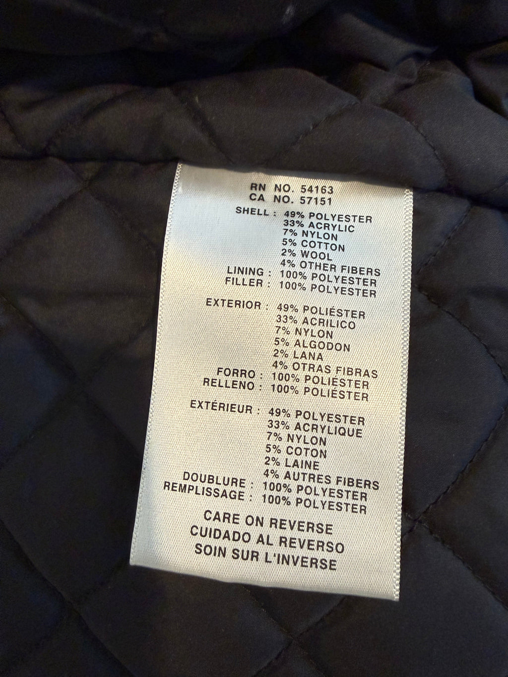 Text label on a dark quilted fabric background