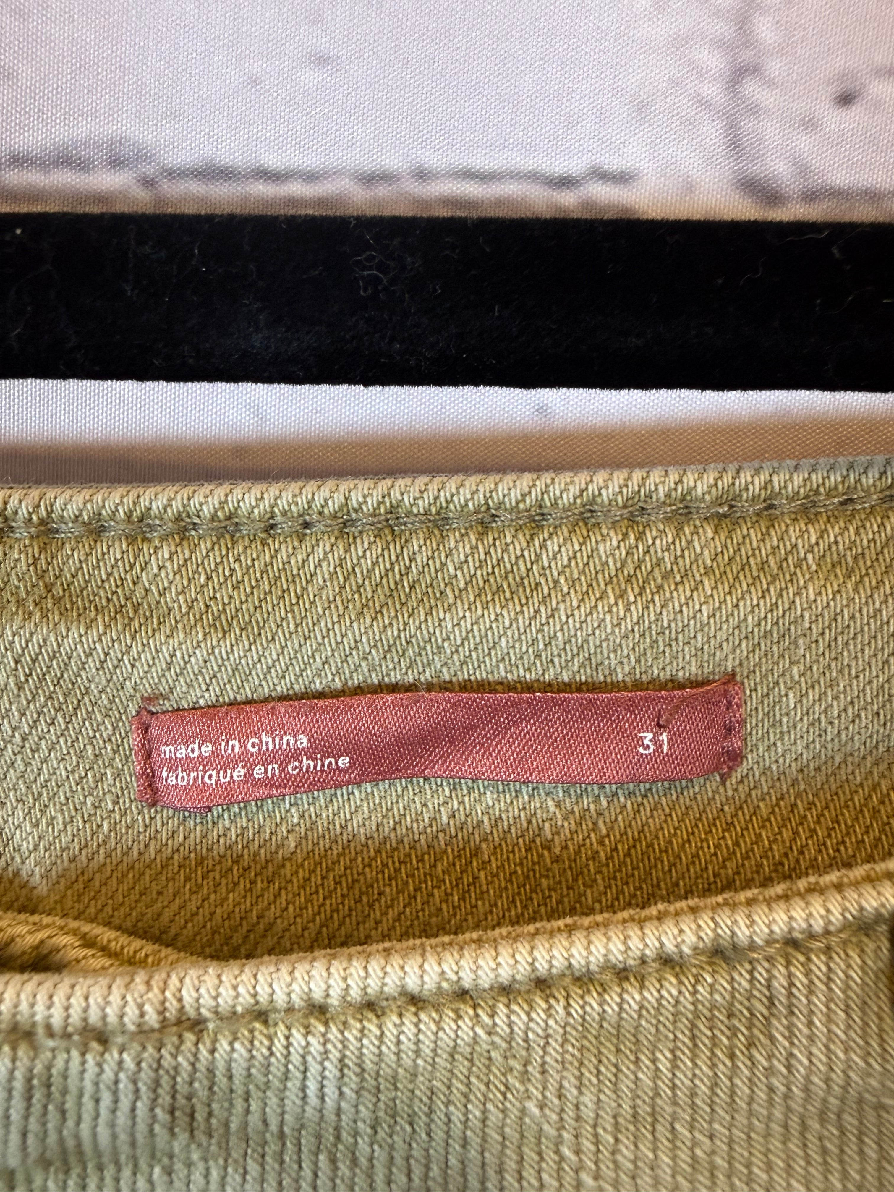 Close-up of a fabric tag on a textured beige background