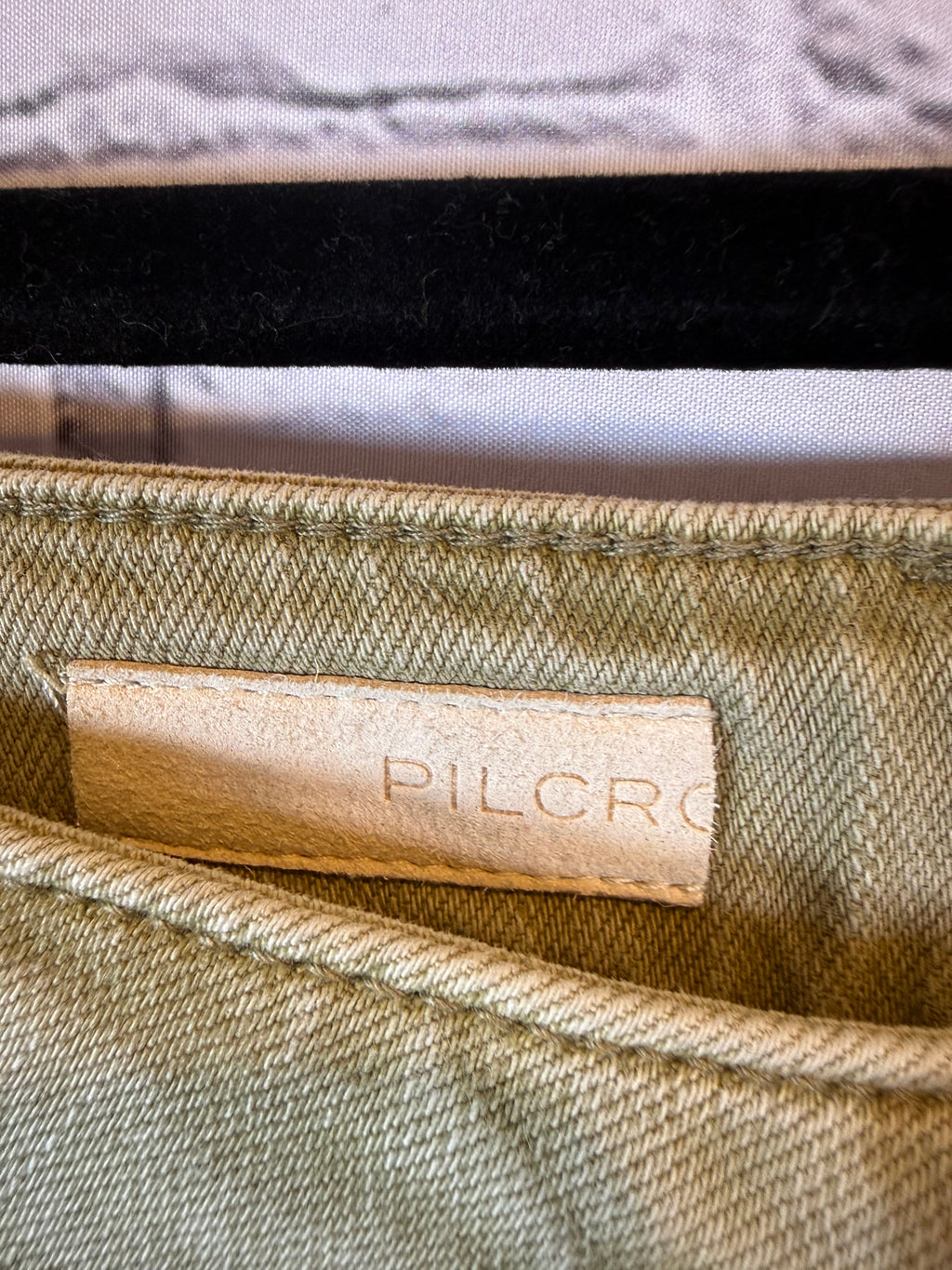 Close-up of a label on a textured fabric surface with 'Pilcro' branding.
