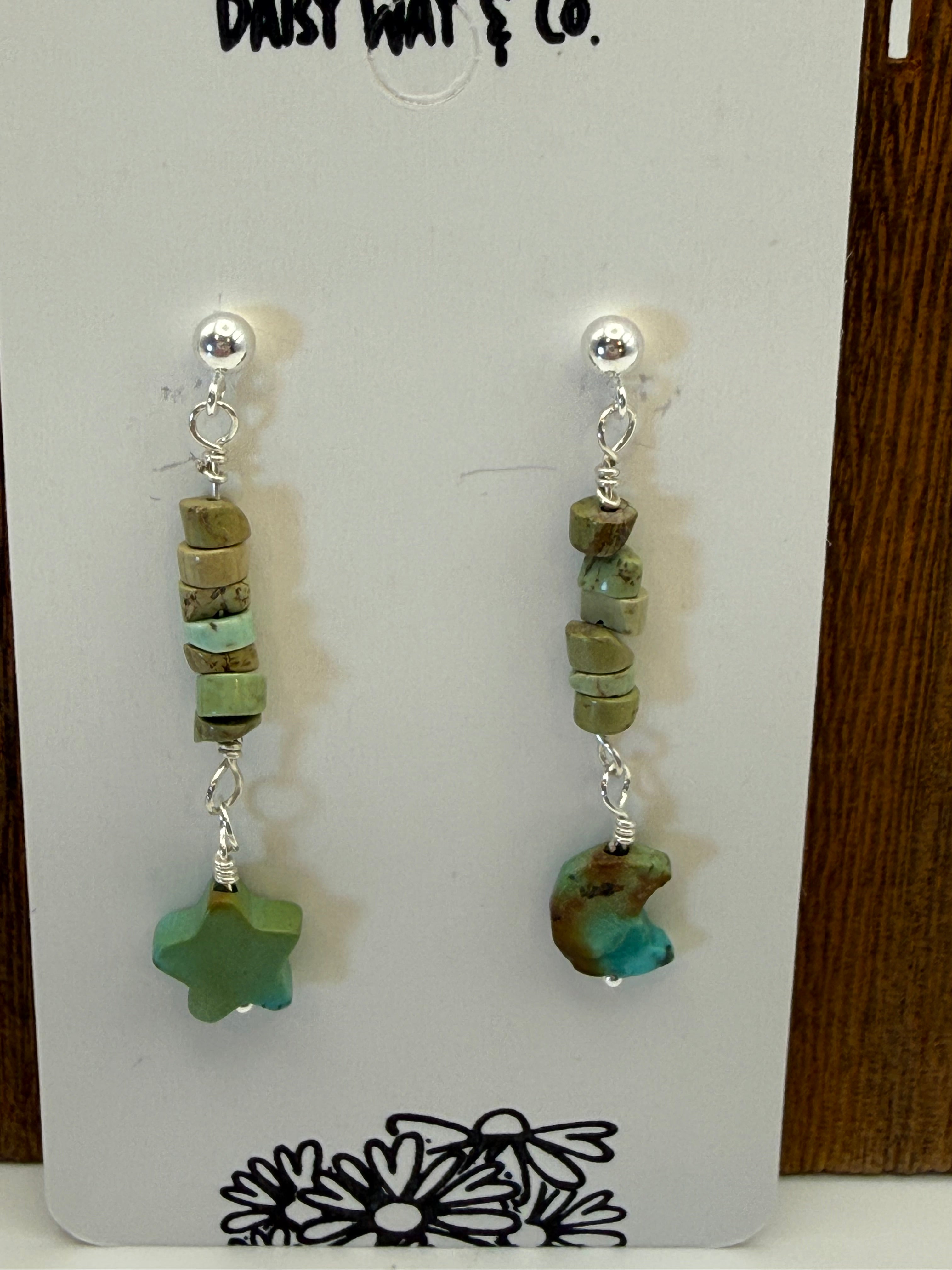 Pair of beaded earrings on a branded card with 'Daisy Way & Co.' design.
