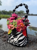 Colorful decorative zebra print handbag with flowers and a beaded handle