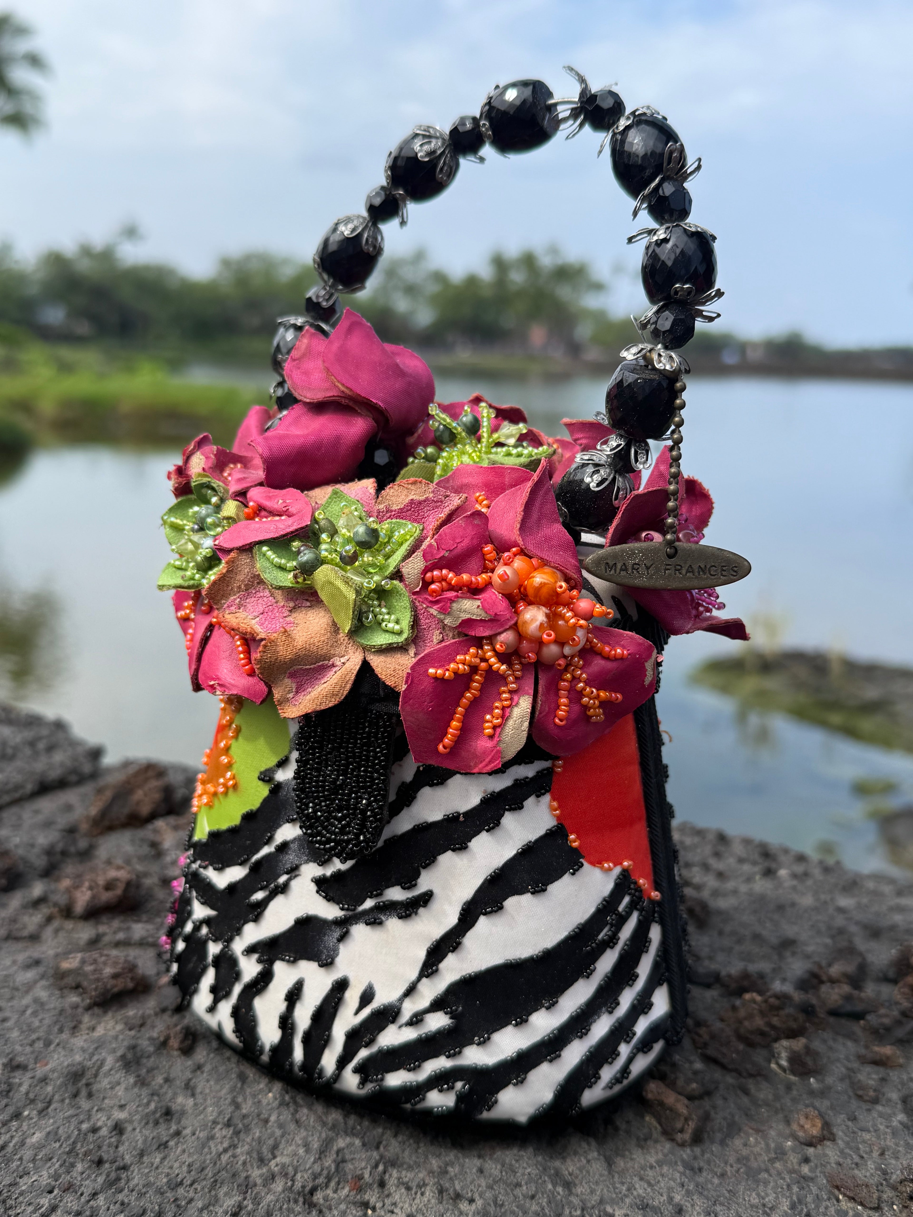 Colorful decorative zebra print handbag with flowers and a beaded handle