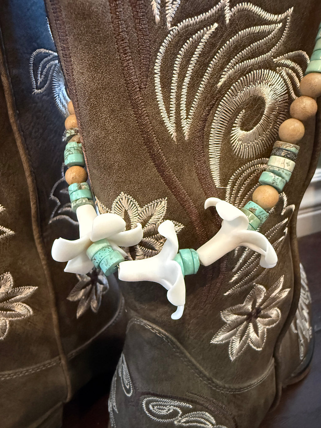 brown boots with decorative beaded lei with clay flowers and turquoise beads